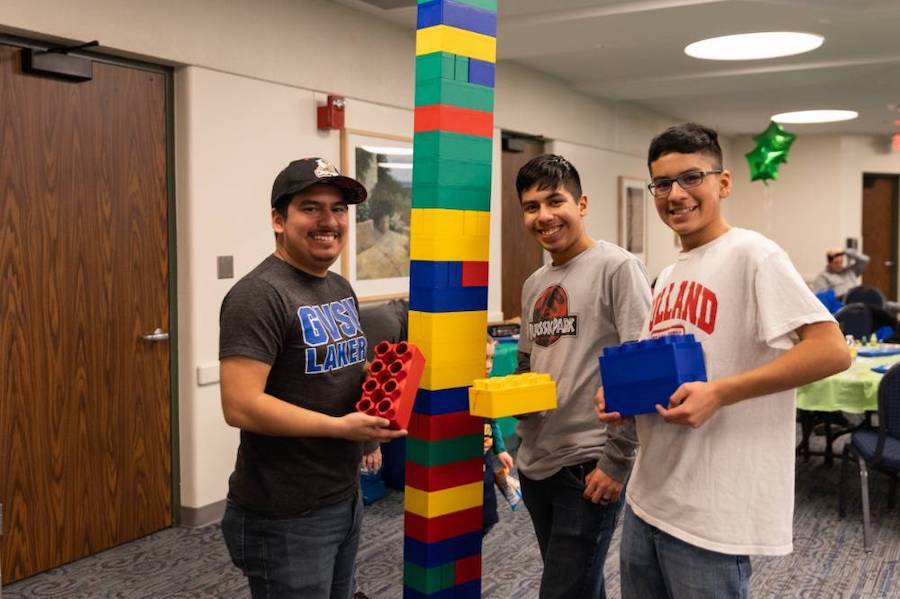 Three siblings building some lego towers for Sibs & Kids Weekend